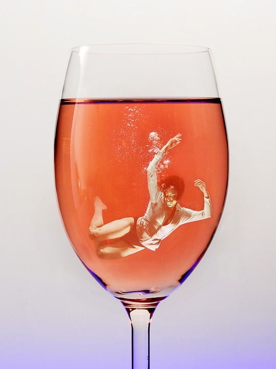 alt="woman drowning in glass of wine"