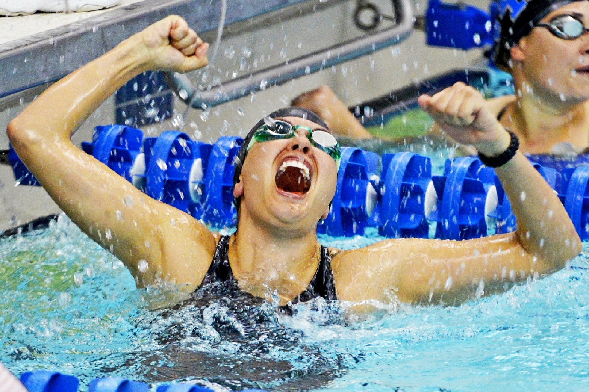 alt="female swimmer celebrating win"